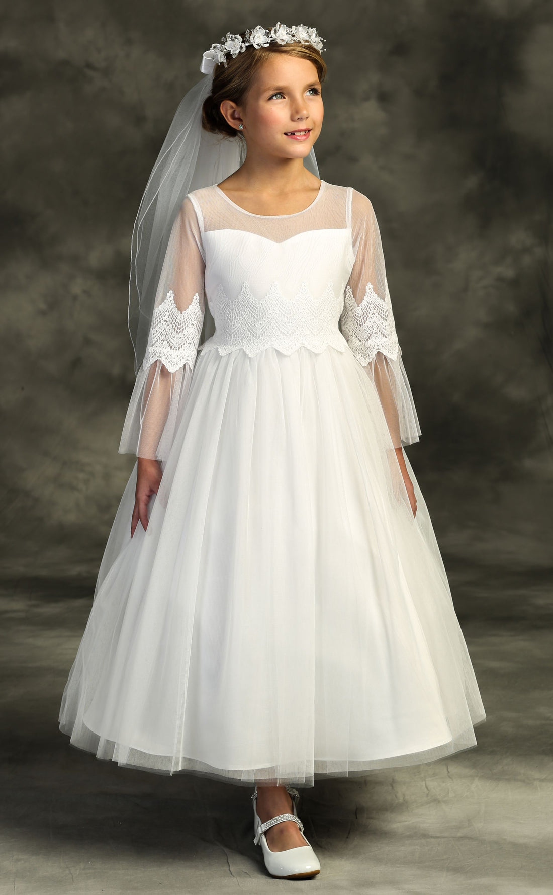 girl wearing white communion dress with veil 